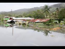 Buildings swallowed by rising floodwaters in Content, Manchester, last October.