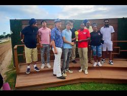 Connections of FUNCAANDUN react during the presentation ceremony, after their charge, ridden by Robert Halledeen, had won the Alexander Hamilton Memorial Trophy ahead of SUPER NATURAL POWER (Raddesh Roman) over seven furlongs at Caymanas Park on Saturday, March 14.