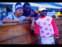 Jockey Tevin Foster (right) interacts with turfites after guiding HIMAYA, running at odds of 5-1, to victory in the Reggae Skanking Sweet Trophy over seven furlongs, at Caymanas Park on Saturday, October 12. The three-year-old Maiden Special Weight event is part of the  BGLC/TOBA Millionaire Series.