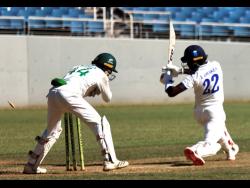 Barbados Pride’s right) Jonathan Drakes is stumped for 94 by wicketkeeper Romaine Morris of the Jamaica Scorpions on the opening day of their West Indies Championship cricket match at Sabina Park yesterday.