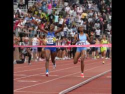 Hydel High’s Nastassia Fletcher (left) celebrates before crossing the finish line to seal her school’s fifth consecutive win in the Penn Relays Championship of America 4x400 metres in Philadelphia. At right is Edwin Allen High’s  Marria Crossfield. 