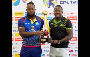 Kyle Mayers (left), captain of the Barbados Royals, and Jamaica Tallawahs skipper Rovman Powell pose with the Caribbean Premier League  trophy.
