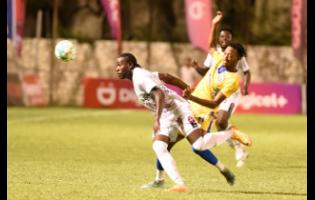 Nicholas Nelson (right) of Molynes United tackles Ronaldo Christian of Chapelton Maroons during their Jamaica Premier League (JPL) game at the Anthony Spaulding Sports Complex yesterday. Molynes won 3-1.