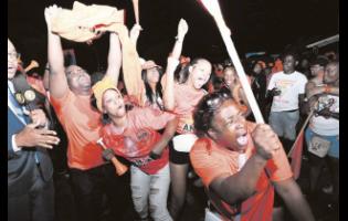 Supporters of Jesse Clarke celebrate at the People’s National Party’s headquarters in St Andrew last night after he defeated Kari Douglas of the Jamaica Labour Party. Douglas, the incumbent, switched parties in 2020.