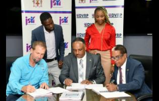 Dr Norman Dunn (seated, right), the state minister in the Ministry Labour and Social Security; Omar Sweeney (seated at centre) managing director, Jamaica Social Investment Fund; and Anthony Sampson (seated, left), operations director, S&G Road Surfacing Materials Limited, participating in the signing of the $197-million contract for the Annotto Bay Coastal Protection Beach Nourishment Project.


