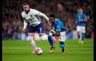 Brazil’s Vincius Junior (right)  is tackled by England’s Kyle Walker during an international friendly match between England and Brazil, at Wembley Stadium in London, Saturday, March 23, 2024. 