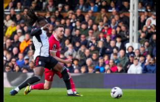 Liverpool’s Diogo Jota scores their third goal during the English Premier League football match at Craven Cottage stadium in London, yesterday. Liverpool won 3-1.