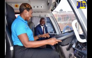 Juliet Cuthbert Flynn, state minister in the Ministry of National Security, familiarises herself with the features in one of the 12 new vehicles added to the Department of Correctional Services’ fleet. Looking on is Commissioner of Corrections, Brigadier (ret’d) Radgh Mason.