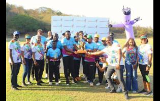 Jamaica Cricket Association CEO Courtney Francis (third right) presents the winning trophy to members of Junction Valley as representatives from Caribbean Airlines look on after the recemt Caribbean Village Cricket series in St Ann.