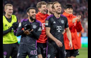 (From left) Noussair Mazraoui, Thomas Müller and Harry Kane of Bayern Munich celebrate in front of the crowd after the German Bundesliga football match against FC Union Berlin at the An der Alten Forsterei stadium in Berlin, Germany last Saturday. Bayern won 5-1.
