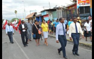 Members of the church community walking through Spanish Town to the mass meeting on Sunday night.