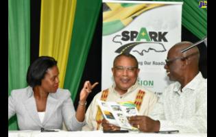 Local Government Minister Desmond McKenzie (right) engages with Anthony Hylton, member of parliament, St Andrew Western (centre), and Kedesha Rochester, director, Constituency Development Fund, during a SPARK townhall meeting in Duhaney Park, St Andrew.
