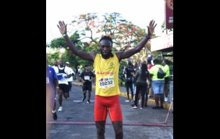 Kemar Leslie celebrates his 10K victory in the Jill Stewart MoBay City Run 10K/5K Run and Walk at the Old Hospital Park in Montego Bay, St. James, yesterday.