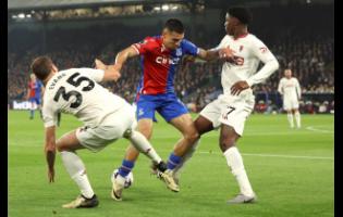 Crystal Palace’s Daniel Munoz (centre) takes on Manchester United’s Jonny Evans (left) and Kobbie Mainoo during the English Premier League football match at Selhurst Park stadium in London, England, yesterday. Palace won 4-0.