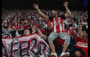 Argentina’s River Plate fans wait for the start of a Copa Libertadores Group H football match against Uruguay’s Nacional in Montevideo, Uruguay, on Tuesday.