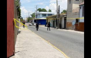 Police cordon off the area where men reportedly engaged the police in a shootout early yesterday in downtown Kingston.