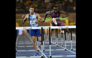 United States of America's Daniel Roberts (right) wins the men's 110m hurdles at the Jamaica Athletics Invitational at the National Stadium tonight.