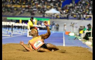 Jaydon Hibbert lands in the pits during the men's triple jump at the Jamaica Athletics Invitational at the National Stadium tonight.