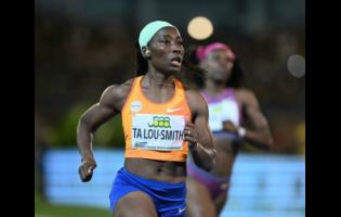 Ivory Coast's Marie-Josée Talou-Smith eases as she wins the women's 100 metres at the Jamaica Athletica Invitational at the National Stadium tonight.