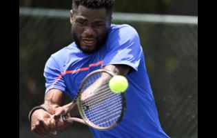 Ghana’s Abraham Asaba plays a forehand shot to United States of America’s Mitchell Dobek during their International Tennis Federation (ITF) World Tennis M15000 tournament at the Eric Bell Tennis Centre in Kingston yesterday. Asaba won 6-1, 6-1.