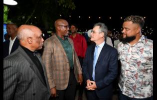 France Ambassador to Jamaica, Olivier Guyonvarch (second right), has the attention of Jamaica Olympic Association (JOA) President Christopher Samuda (left), Chef De Mission Ian Kelly (second left) and JOA Secretary General and Chief Executive Officer Ryan Foster during yesterday’s Paris Olympic Games launch at Terra Nova Hotel in St Andrew.