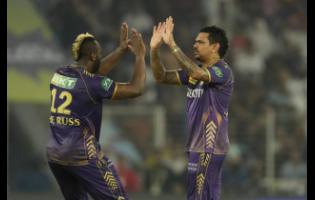 Andre Russell (left) and Sunil Narine of the Kolkata Knight Riders celebrate after the dismissal of Sunrisers Hyderabad batsman Sanvir Singh during yesterday’s Indian Premier League playoff match in Ahmedabad.