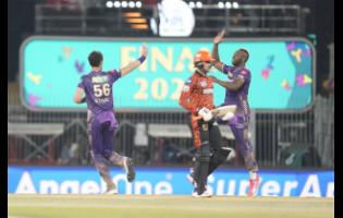 Kolkata Knight Riders’ Mitchell Starc (left) celebrates with teammate Andre Russell after the fall of the wicket of Sunrisers Hyderabad’s Abhishek Sharma during the Indian Premier League final in Chennai, India yesterday.