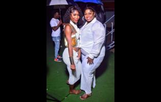 Leneisha (left) and Jackie stun in pristine white attire, striking poses that steal the spotlight at the recent Soul Food Tuesdayz event, hosted at Hyde Park Football Field on Lower Mall Road in St Andrew.