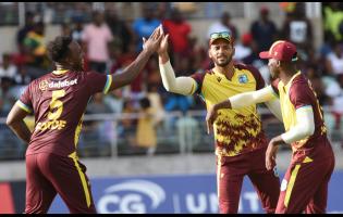 West Indies stand-in captain Brandon King (centre) celebrates the fall of a South African wicket with Matthew Forde (left) and Shamar Joseph during their opening T20 match at Sabina Park on Thursday, May 23. 
