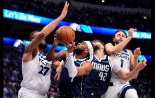 Dallas Mavericks guard Jaden Hardy (second left) is fouled by Minnesota Timberwolves centre Rudy Gobert (27) as he tries to score during the second half in Game 4 of the NBA basketball Western Conference finals on Tuesday in Dallas.