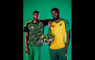 Reggae Boyz Shamar Nicholson (right) and Damion Lowe display the new Adidas home-and-away jerseys. 