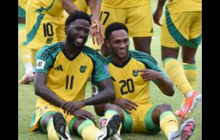 Shamar Nicholson (left) and Renaldo Cephas celebrate  after Jamaica’s goal during yesterday’s 2026 World Cup qualifying match against the Dominican Republic at the National Stadium. Cephas provided the assist for Nicholson’s 16th minute goal.