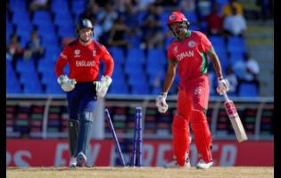 Oman’s Kaleemullah (right) reacts after being bowled by England’s Adil Rashid for five runs during an ICC Men’s T20 World Cup cricket match at Sir Vivian Richards Stadium in North Sound, Antigua and Barbuda, yesterday.