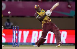 West Indies captain Rovman Powell plays a shot during a T20 World Cup cricket match against Uganda at Guyana National Stadium in Providence, Guyana, Saturday, June 8.