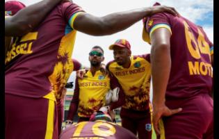 West Indies’ Roston Chase (second right) gathers with teammates prior to the start of their ICC Men’s T20 World Cup cricket match against Papua New Guinea at the Guyana National Stadium in Providence, Guyana, on June 2. West Indies went on to win the match by five wickets.  