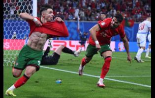 Portugal’s Francisco Conceicao (left) celebrates after scoring his side’s second goal during a Group F match between Portugal and Czech Republic at the Euro 2024 football tournament in Leipzig, Germany yesterday.