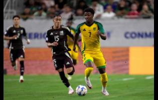 Jamaica’s Demarai Gray (right) brings the ball up the field as Mexico’s Uriel Antuna defends during their Copa America match on Saturday, June 22, 2024, in Houston, Texas.