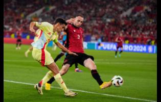 Spain’s Jesus Navas (left) shoots the ball next to Albania’s Mario Mitaj during a Group B match between Albania and Spain at the Euro 2024 football  tournament in Dusseldorf, Germany yesterday.