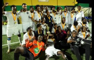 Members of the Chapelton Maroons squad and some supporters  celebrate with winning trophy after  the Jamaica Football Championships (Tier II) final  at UWI-JFF Captain Horace Burrell Centre Of Excellence on Sunday, June 23, 2024