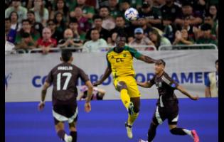 Jamaica’s Greg Leigh (22) heads the ball against Mexico during a Copa America Group B  match in Houston, Saturday, June 22, 2024. 