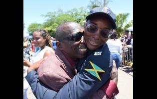 Ronique Rodney (right) gets a congratulatory hug from her father Loren Tugman Rodney shortly after she graduated from the National Police College of Jamaica in Twickenham Park, Spanish Town, St Catherine, on Tuesday. She was the valedictorian of her batch.