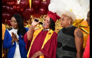 Burn victim Alecia King (centre) performs a rendition of Chronixx’s ‘I Can’ at her graduation, supported by her guardian Julian Mendez (right) and Miss Universe Jamaica finalist Latoya Malcolm. 