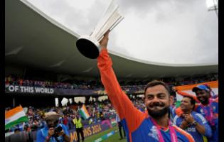India’s Virat Kohli carries the winners’ trophy as he celebrates after India won the ICC Men’s T20 World Cup final against South Africa at Kensington Oval in Bridgetown, Barbados, on Saturday, June 29. 
