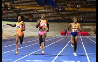 Shericka Jackson (centre)  powering to victory in the women’s 200 metres final in 22.39 seconds at the JAAA/Puma National Junior and Senior Championships yesterday. Lanae-Tava Thomas (left)  placed second in 22.34 and Niesha Burgher (right), third in 22.49.