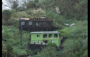 Houses damaged by Hurricane Beryl are spotted in Kingstown, St. Vincent and the Grenadines, on Monday. 