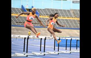 Janieve Russell (left) and Andrenette Knight competing in the heats of the  400m hurdles on  Day One of the JAAA/Puma National Junior and Senior Championships at the National Stadium on Thursday, June 27.