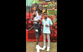 Dancehall artiste Laa Lee (left) poses with 12-year-old Dwight ‘DJ Brainz’ Francis.