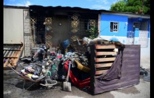 Residents lay out household items which were damaged in the fire.