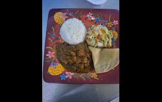 Curried goat with roti and vegetables at the festival.
