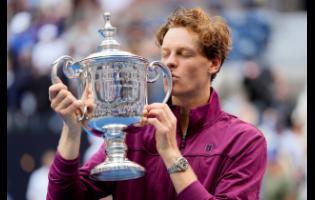 Jannik Sinner of Italy kisses the championship trophy after defeating Taylor Fritz of the United States in the men’s singles final of the US Open tennis championships yesterday in New York.